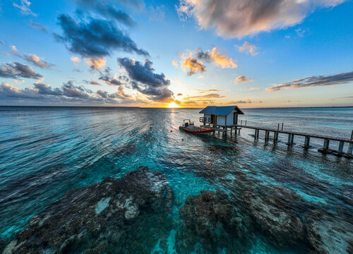 Aerial view of boat shed and dock on lagoon at sunset Fakarava French Polynesia