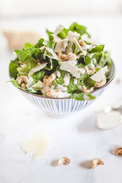 Caesar Salad with roasted cashews in a bowl