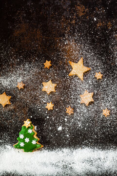 Christmas Cookies and icing sugar on baking tray