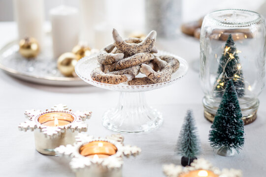 Poppy seed cookies on glass cake stand at Christmas time