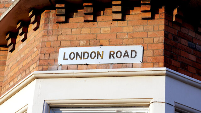 London Road sign, street name plate, brick wall, UK architecture