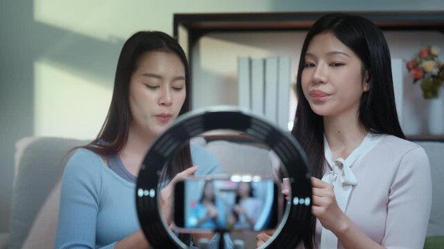 Beauty bloggers influencers live streaming makeup tutorial with ring light and smartphone in cozy home studio, creators share skincare and nail care tips, friendly talk, authentic vibe, calm session