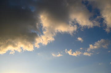 Obraz premium Cloudscape with colorful clouds during sunrise or sunset golden light illuminating edges of dark 