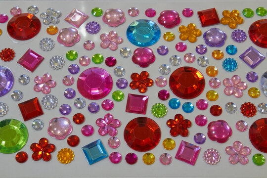 Colorful rhinestone stickers, rhinestone stickers and decorative stones for creativity. Concept of needlework, children's creativity and scrapbooking.