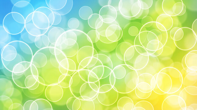 Abstract natural background with bright green and blue bokeh circles.