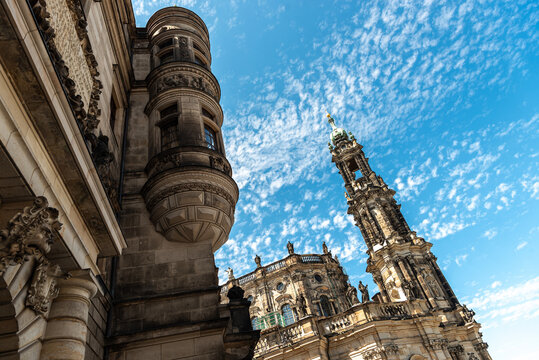 Historic architecture of Dresden Castle and the Cathedral of the Holy Trinity tower against a blue sky with clouds in Saxony, Germany