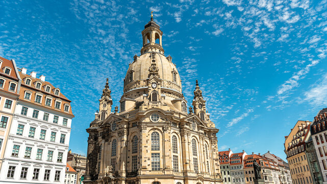 Dresden Frauenkirche and historic Neumarkt square buildings under a blue sky with clouds, Saxony, Germany