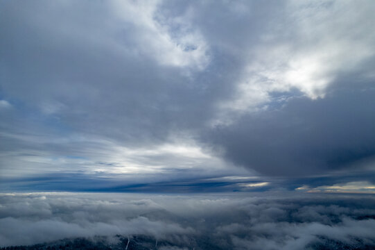 Aerial view of a dense cloud layer covering the landscape near Seebach, with dramatic overcast skies above the Black Forest region in Seebach, Baden-Wurttemberg, Germany.