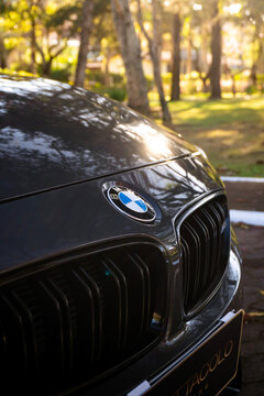 Dark grey BMW M3 hood badge and front grille close up, High performance sports sedan exterior details