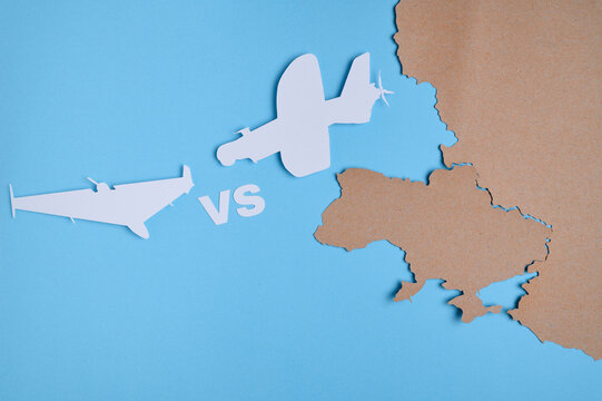 Two fighter jet silhouettes facing off with VS text and Ukraine map