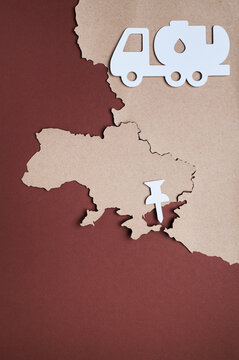 Paper cutout map of Ukraine with pushpin marking Crimea on red background
