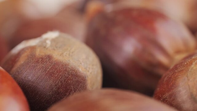 Fresh chestnut, supermarket food, Oven roasted chestnuts with sliced peel on wooden board, spanish traditional winter dish.
