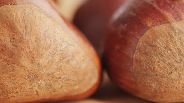 Fresh chestnut, supermarket food, Oven roasted chestnuts with sliced peel on wooden board, spanish traditional winter dish.