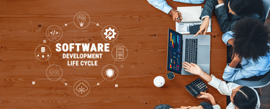 Team Collaboration in Software Development Life Cycle with Laptops and Notebooks on Wooden Table for Project Management and Planning Quark.