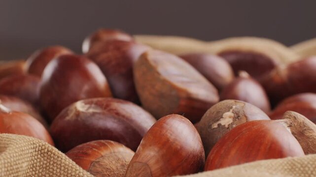 Fresh chestnut, supermarket food, Oven roasted chestnuts with sliced peel on wooden board, spanish traditional winter dish.