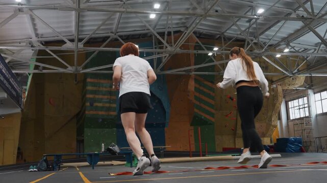 Rapid badminton sprint training. Players perform explosive movements and quick exchanges on court. Athletes engage in demanding sprint drills focusing on endurance and rapid response skills