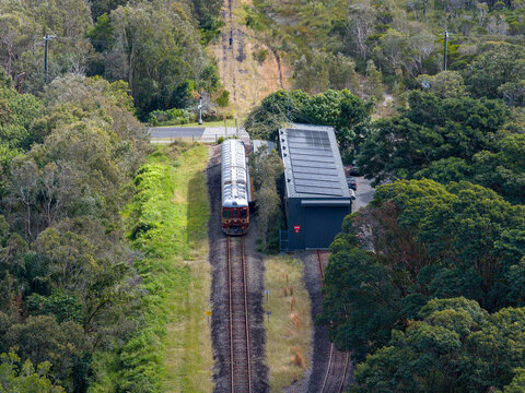 Aerial view of the world's first solar power train at the station surrounded by lush forest in Byron Bay, New South Wales, Australia.