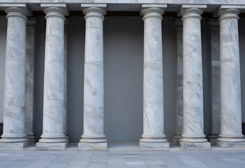 Fototapeta premium Row of classical marble columns with intricate circular patterns and a gray wall background, the architectural details suggest a historical or institutional building, providing a sense