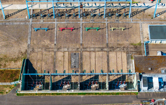 Aerial view of the electrical substation in Vogelgrun, featuring high-voltage equipment, transformers, and power lines on a gravel surface in Vogelgrun, Grand Est, France.