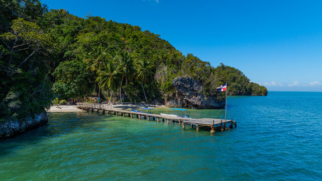 Aerial view of a wooden dock at Bahia de San Lorenzo in Los Haitises National Park with a Dominican Republic flag, Sabana de la Mar, Hato Mayor Province, Dominican Republic.