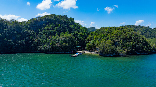 Aerial view of Los Haitises National Park with limestone karst, mangroves, and dock on turquoise waters of Bahia de San Lorenzo, Sabana de la Mar, Hato Mayor Province, Dominican Republic.