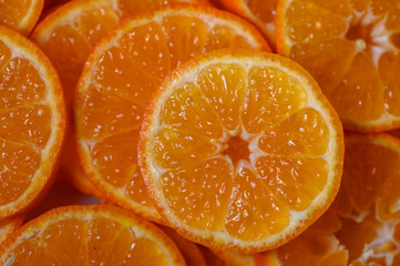 Bright orange slices showcase the juicy freshness of citrus in a vibrant display on a wooden surface © Михаил Шорохов