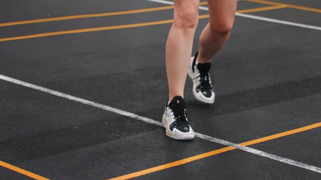 White athlete badminton quick feet across court, solo speed drill focusing on pivots and landings, closeup legs and shoes on marked flooring, highenergy training with emphasis on reaction