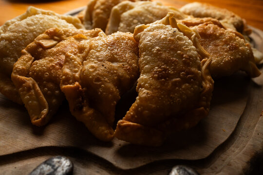 Detailed shot of traditional homemade empanadas showcasing crispy blistered dough crusts