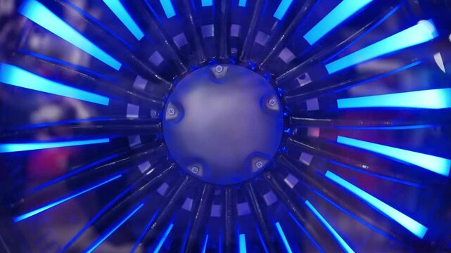 Futuristic jet engine turbine with blue light illumination, representing technology and power