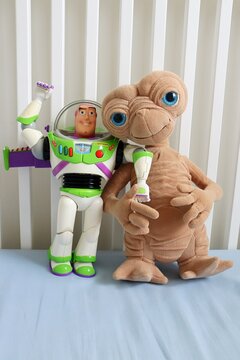 Salvador, Brazil - August 7, 2026: Toy figures of E.T. the Extra-Terrestrial and Buzz Lightyear posed together. Universal Pictures and Disney Pixar toy figures.