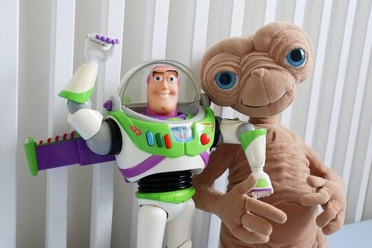 Salvador, Brazil - August 7, 2026: Toy figures of E.T. the Extra-Terrestrial and Buzz Lightyear posed together. Universal Pictures and Disney Pixar toy figures.
