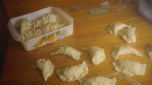Homemade Latin Pastry Turnovers Arranged on Floured Table Before Baking