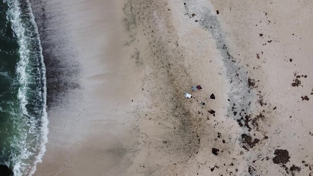 Aerial view of people walking on a beach in paracas, peru