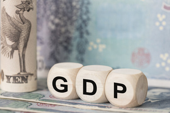 Japan symbol GDP, Gross Domestic Product on wooden blocks spelling GDP and Japanese Yen banknotes. Japan financial market, macroeconomic indicators, Tokyo stock exchange Asian economy 