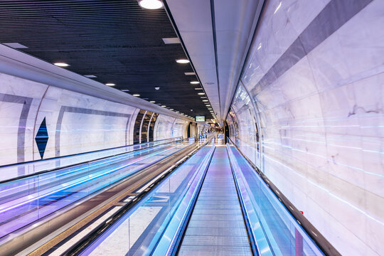 Monaco, Monaco - July 17, 2026: Pedestrian tunnel inside the rock with illuminated moving walkways leading to Monaco Monte Carlo railway station