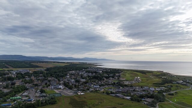 Dornoch is a historic Highland town beside Dornoch Firth, featuring a 1224 cathedral, 1509 castle, bright skies, and coastal scenery.