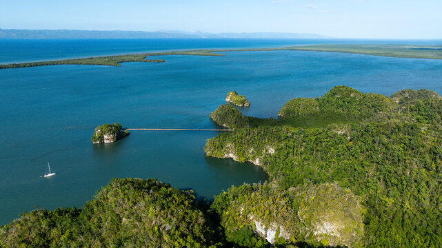Aerial view of Los Haitises National Park with limestone karst islands, mangrove forests, and a boat in Samana Bay, Sabana de la Mar, Hato Mayor Province, Dominican Republic.