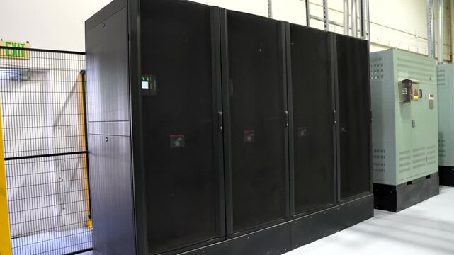 Wide Shot of Black Server Cabinets in Data Center Warehouse with Active Lights
