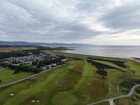 Dornoch is a historic seaside town in Scotland, overlooking the coast at sunset, with glowing skies, peaceful sea, sandy shores, and heritage.