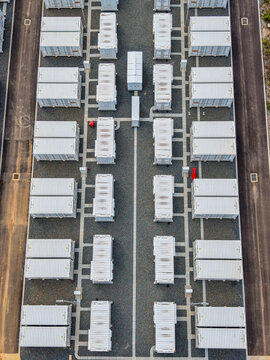 Aerial view of the Brendale BESS facility featuring rows of white battery storage containers arranged on a gravel site with paved access paths in Brendale, Queensland, Australia.