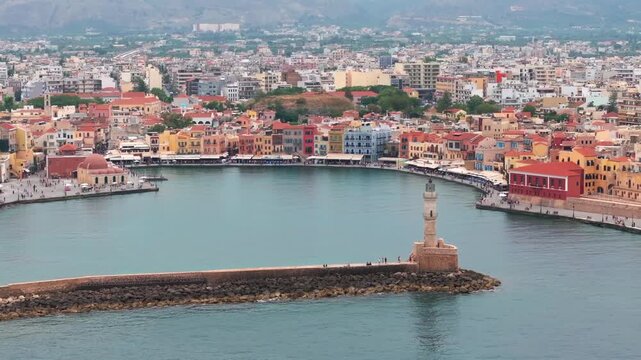  View of Chania with the amazing lighthouse, mosque, venetian shipyards, Crete, Greece.Waves crashing on lighthouse, Beautiful Greece and best scenic places - panorama