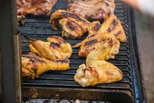 Grilled chicken wings cooking on a barbecue The Concept of summer food