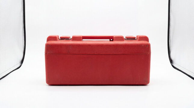 Red Tool Box: A sturdy red tool box with a convenient handle sits ready for use, its robust design promising durability and efficient storage.