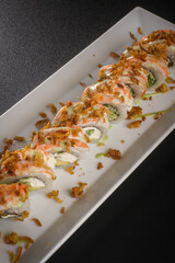 Perspective View of Baked Sushi Rolls on Long White Dish © Ilias