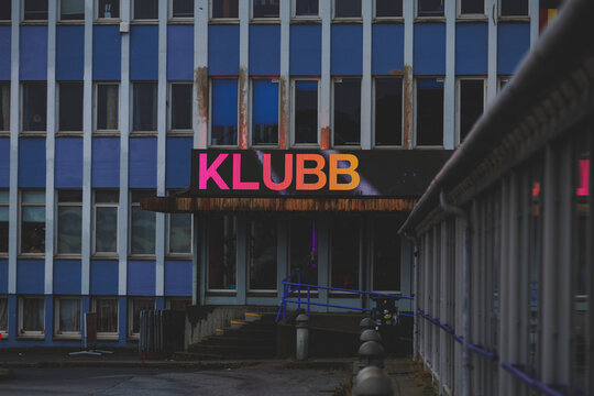 Alesund, Norway - August 2 2026 - Illuminated KLUBB sign on a blue building facade
