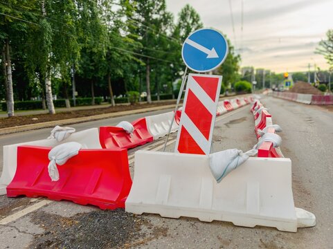 Traffic barricades with directional arrow on street
