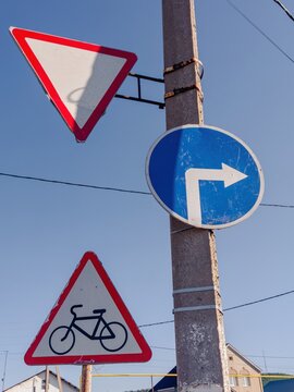 Traffic signs on pole at urban intersection