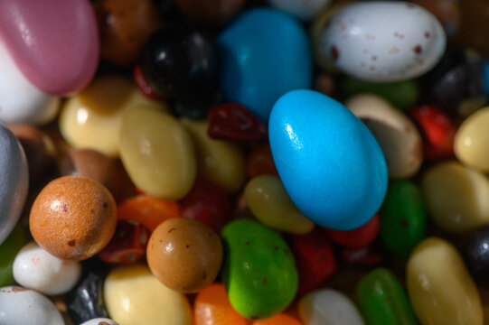 Colorful assortment of candy eggs and sweet treats in vibrant hues for festive