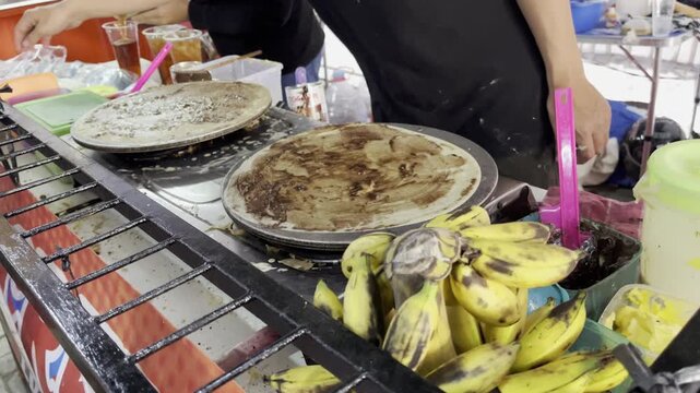 Traditional street food vendor making crispy Indonesian leker cake