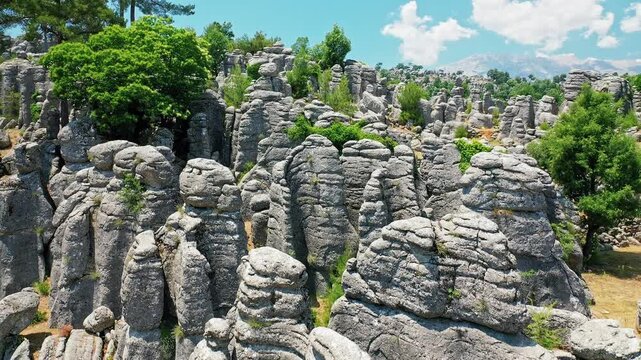 Manavgat Adam Kayalar aerial view showing fantastic conglomerate rocks in Antalya Turkey. Majestic drone shot of unique "Man Rocks" formation surrounded by nature.